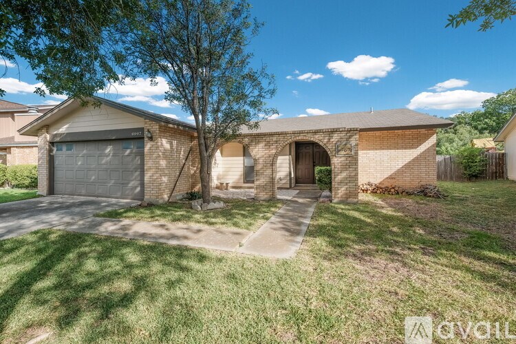 A house with a garage and a driveway is for sale.