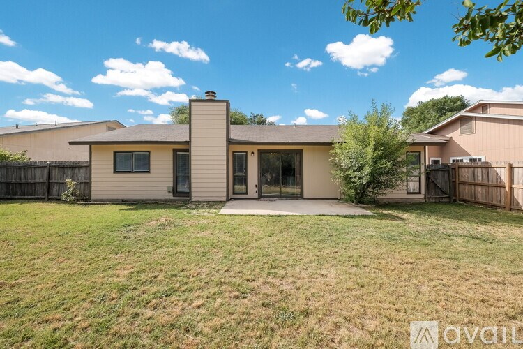 A house with a beige exterior and a large front yard.