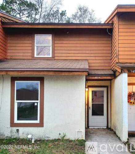 A house with a brown roof and a white door.
