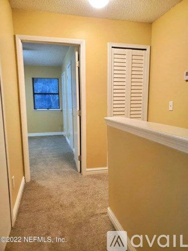 A room with yellow walls and a window.