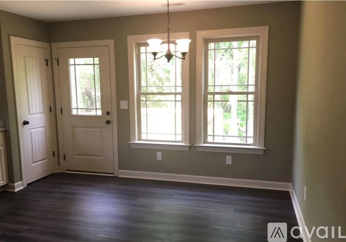 A room with two doors and two windows.