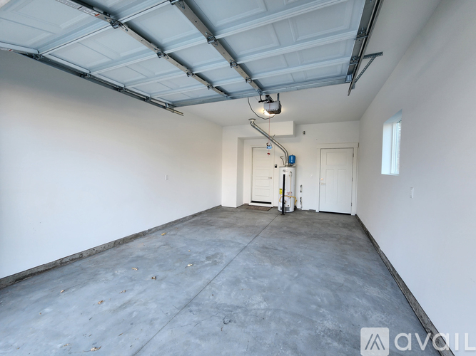 A spacious garage with a concrete floor and white walls.