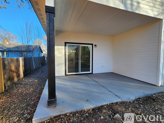 A modern house with a white exterior and a glass door.