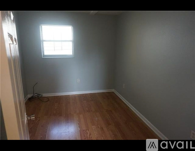 A room with wooden floors and a window.