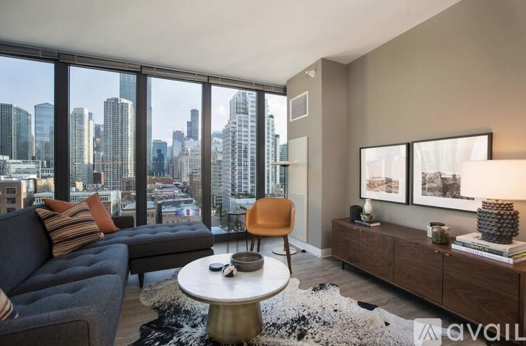 A living room with a view of the city skyline.