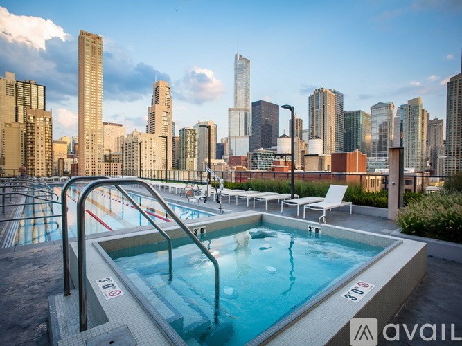 A swimming pool with a city skyline in the background.
