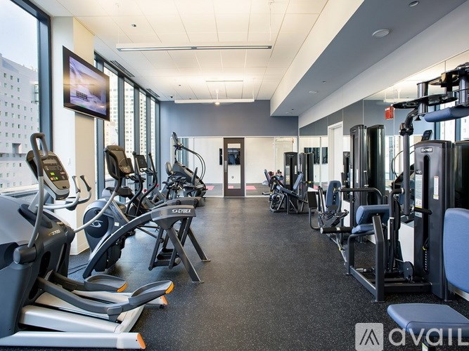 A gym with treadmills, exercise bikes, and other equipment.
