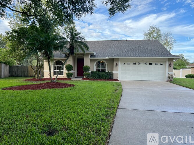 A house with a red door and a garage is for sale.
