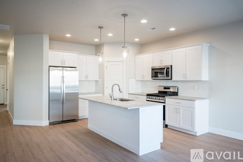 A modern kitchen with white cabinets and a central island.