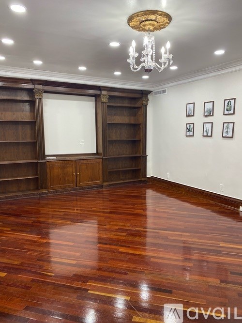 A room with wooden floors and a chandelier.