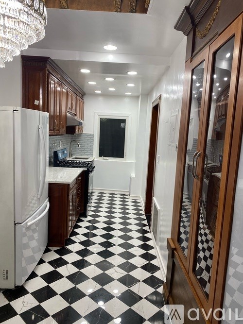 A kitchen with black and white checkered floor.