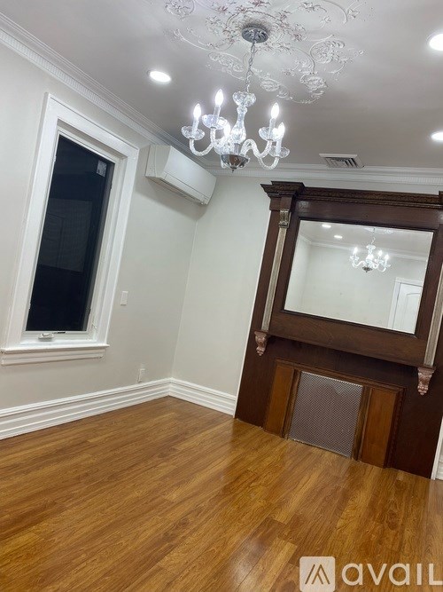 A room with wooden floors and a chandelier.