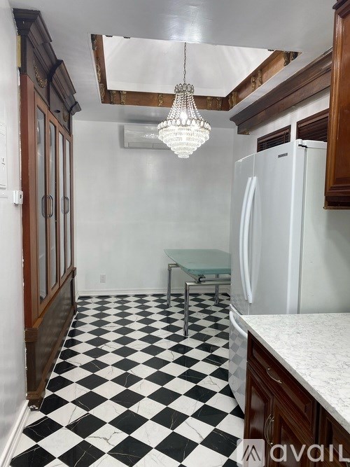 A kitchen with black and white checkered floor.