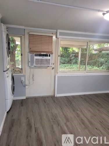 A house with a white door and a small window on the wall.