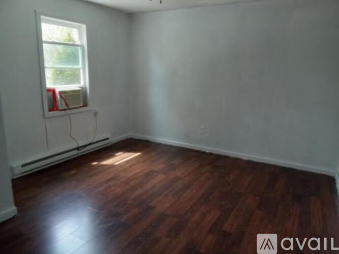 A room with wooden floors and a window.