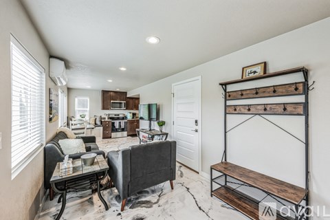 A living room with a dining table and chairs.