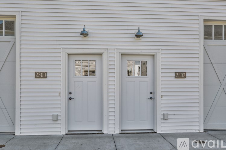 Two white doors with numbers 2300 and 2302 on the wall.