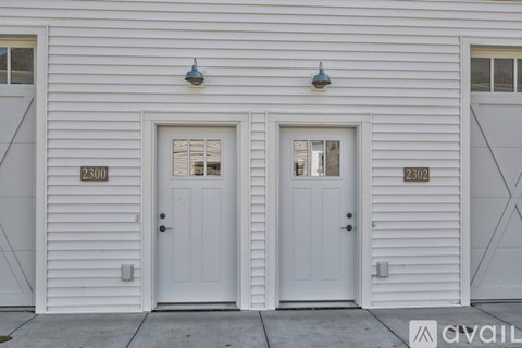 Two white doors with numbers 2300 and 2302 on the wall.