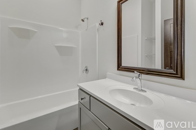A bathroom with a white sink and a white bathtub.