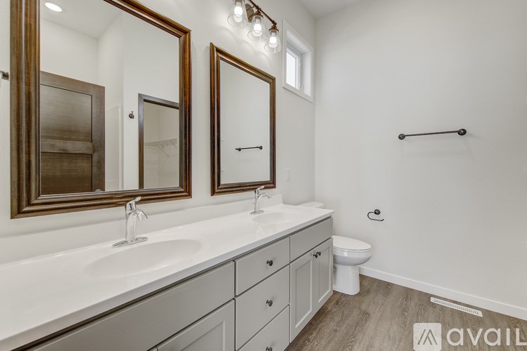 A bathroom with a white countertop and a toilet in the corner.