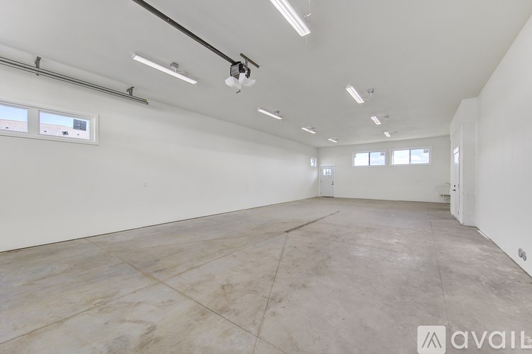 Empty room with white walls and tiled floor.
