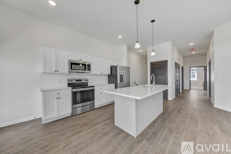 A modern kitchen with white cabinets and a central island.