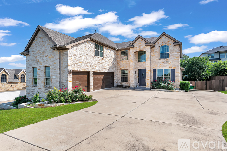 A large house with a driveway in front.