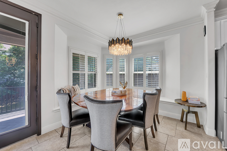 A dining room with a table set for four.