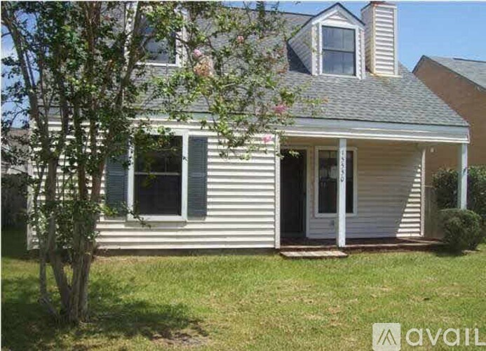 A house with a tree in front of it.