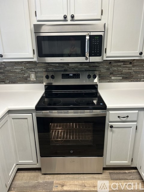 A modern kitchen with a stainless steel oven and microwave.