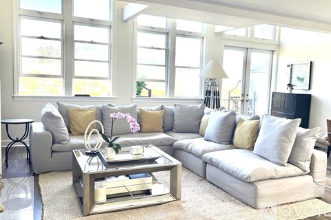 A living room with a grey couch and a coffee table.