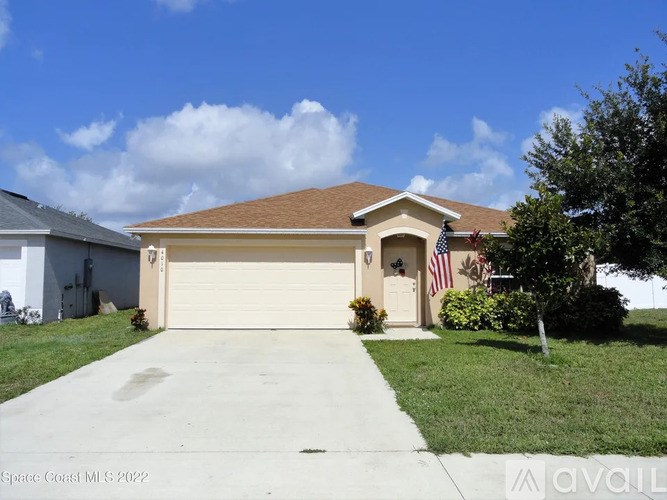 A house with a brown roof and a garage door.
