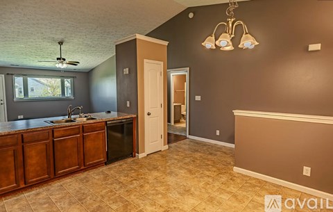 A kitchen with brown cabinets and a white door.