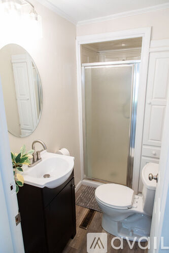 A bathroom with a sink, toilet and shower.