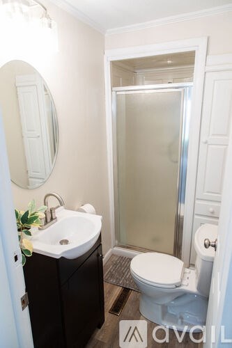 A bathroom with a sink, toilet and shower.