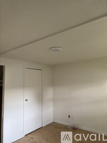 A room with a white ceiling and a white door.