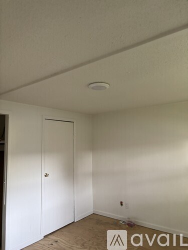 A room with a white ceiling and a white door.