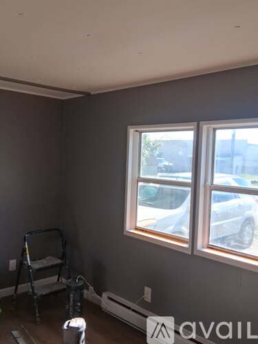 A room with a window and a chair.