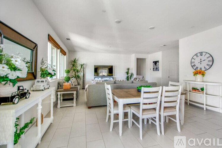 A white dining room with a table set for four.