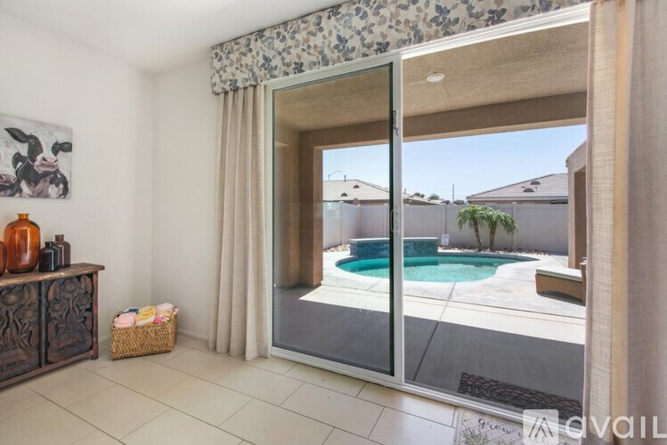 A room with a pool outside.