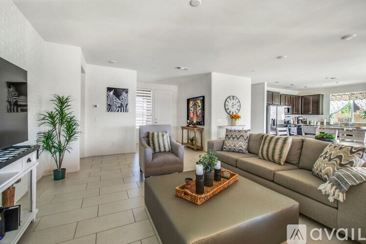 A living room with a brown couch and a coffee table.