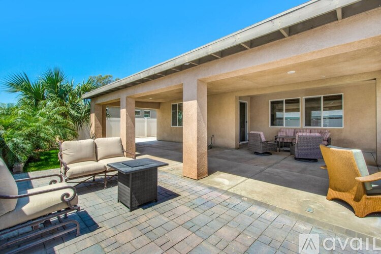 A patio area with a table and chairs is available for rent.