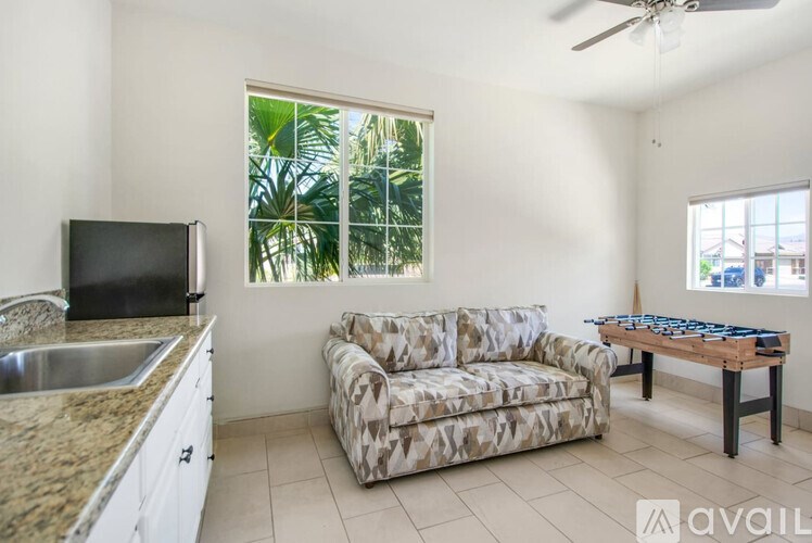 A living room with a couch, a table, and a television.