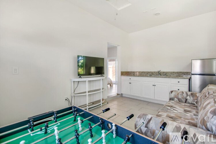 A foosball table is in the middle of a living room.