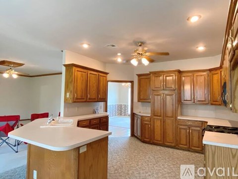 A kitchen with wooden cabinets and a white countertop.
