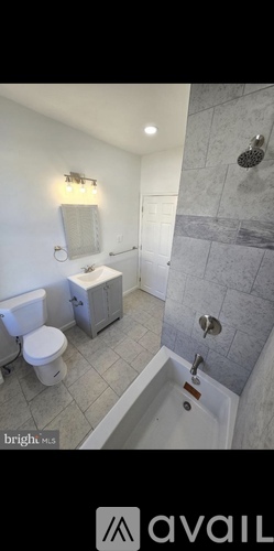 A bathroom with a toilet, sink, and shower.