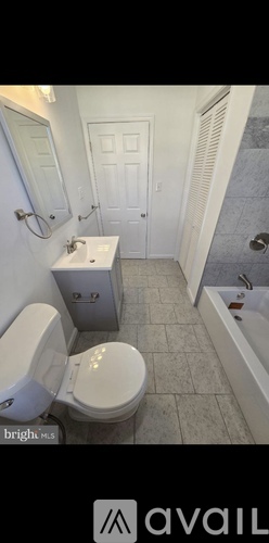 A bathroom with a toilet, sink, and bathtub.