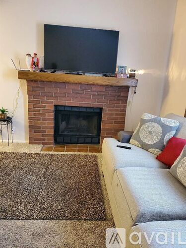 A living room with a fireplace and a couch.
