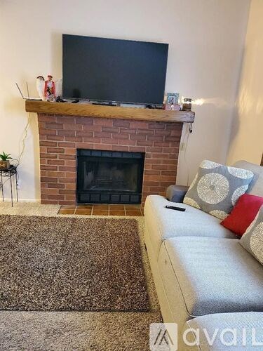 A living room with a fireplace and a couch.