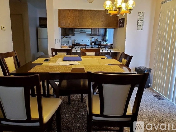 A dining room with a table and chairs.